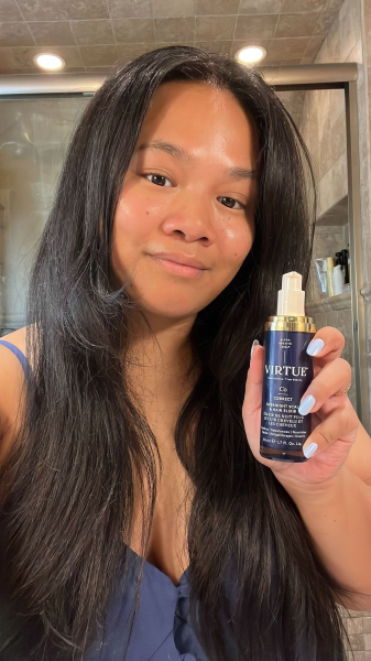 Allure senior editor Jesa Marie Calaor applying Virtue's Overnight Scalp and Hair Elixir